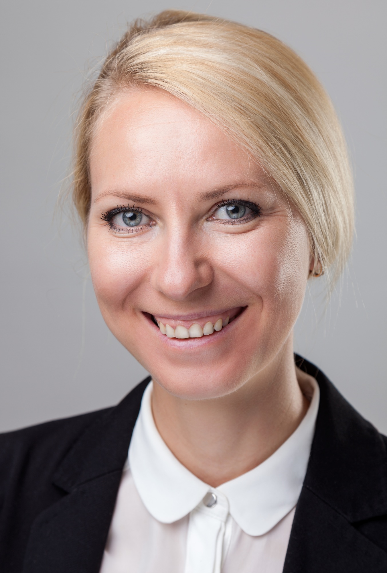Headshot of young and happy business woman
